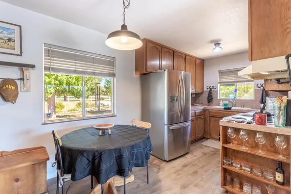 a kitchen with stainless steel appliances granite countertop a sink refrigerator and microwave