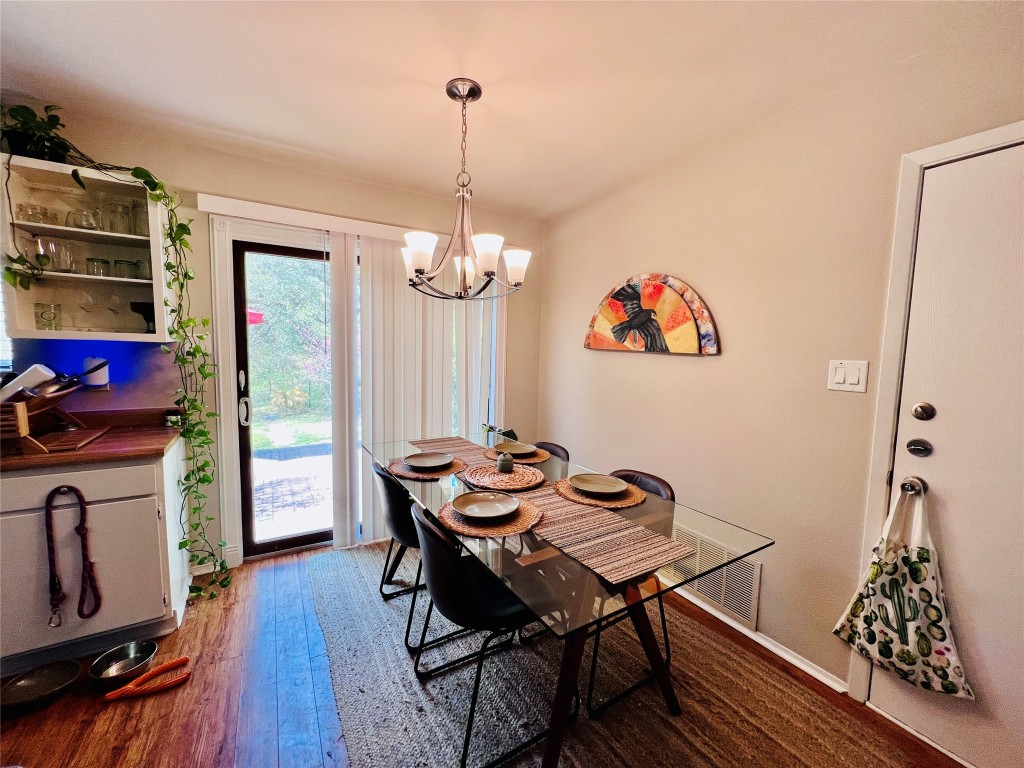 744 Wales Way Austin, TX 78748 - Photo 6 of 15 a view of a dining room with furniture wooden floor and chandelier