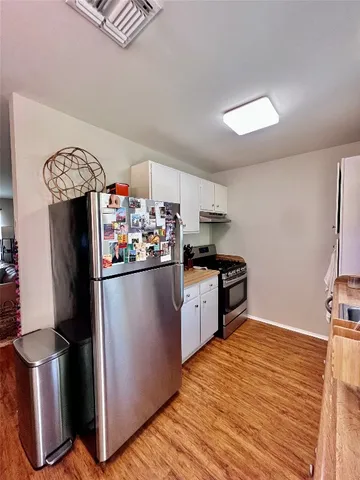 a kitchen with a refrigerator and microwave