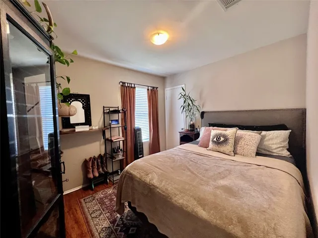 a bedroom with a bed and a dresser