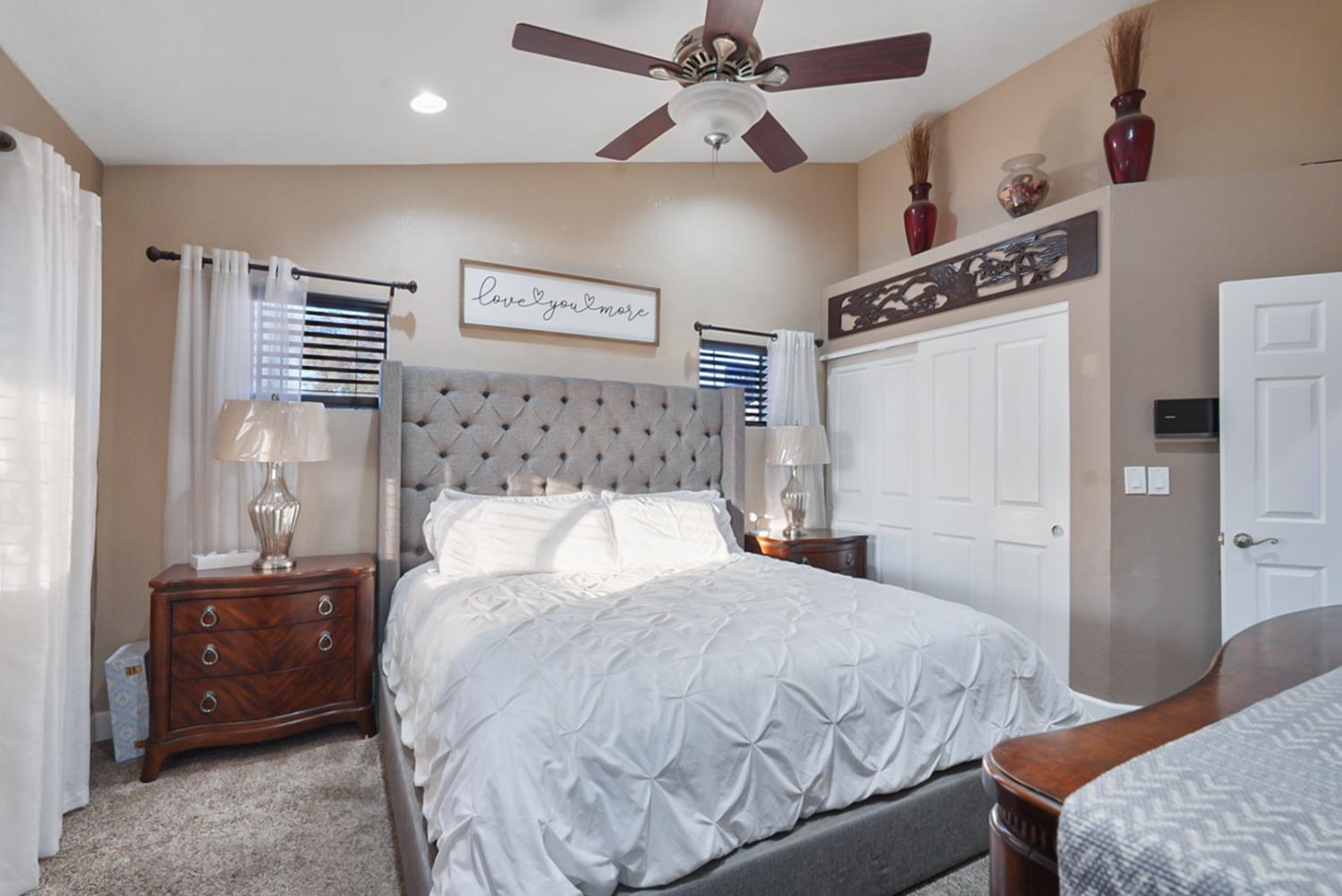 1421 Riverette Drive Modesto, CA 95351 - Photo 16 of 32 a bedroom with a bed and a chandelier