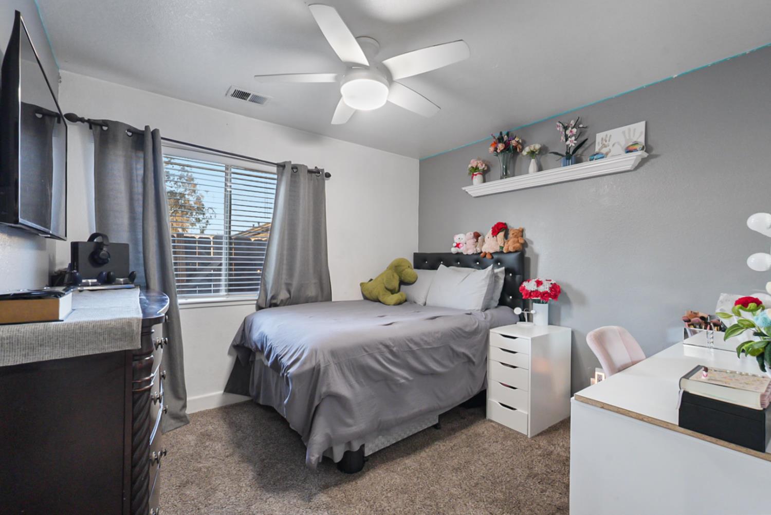 1421 Riverette Drive Modesto, CA 95351 - Photo 20 of 32 a bedroom with a bed and a dresser
