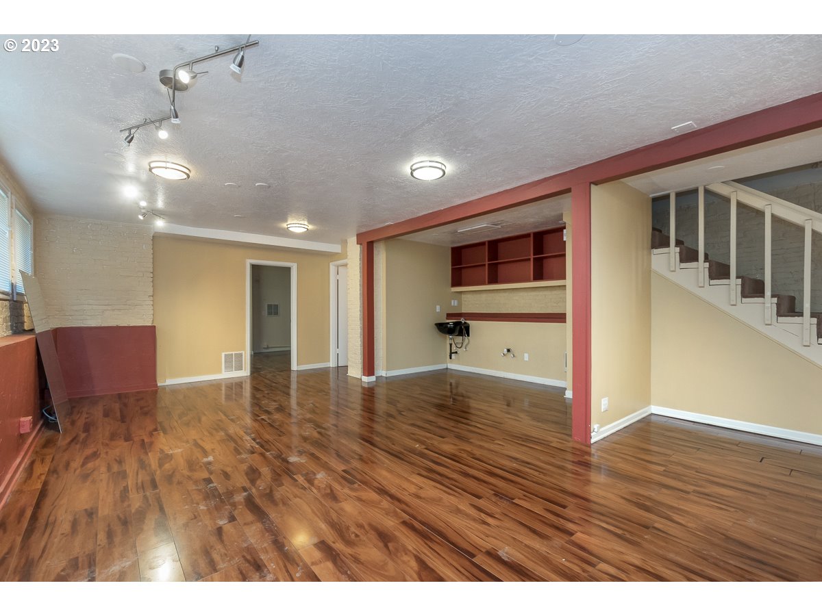 1326 Southwest 12th Avenue Portland, OR 97201 - Photo 23 of 33 a view of an empty room with wooden floor and a window