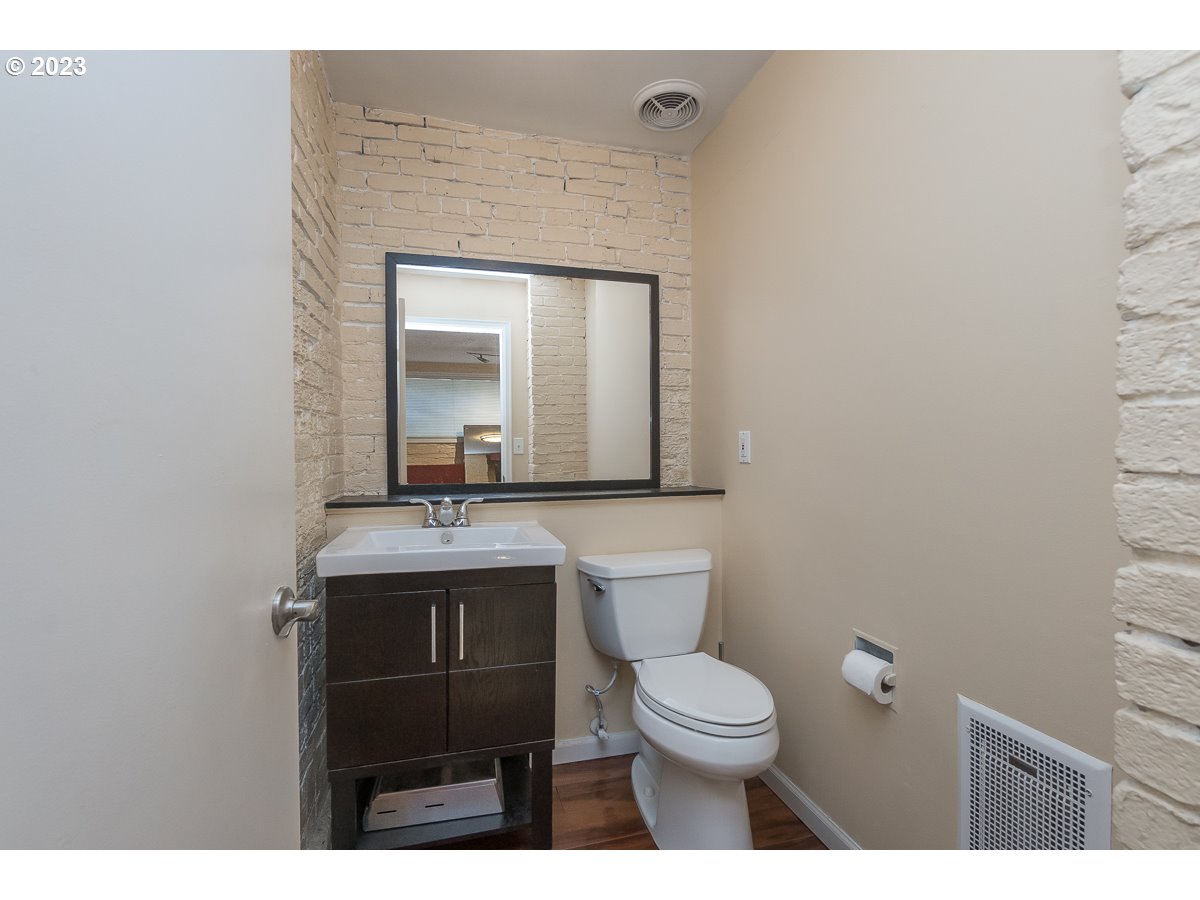 1326 Southwest 12th Avenue Portland, OR 97201 - Photo 27 of 33 a bathroom with a toilet sink vanity and mirror