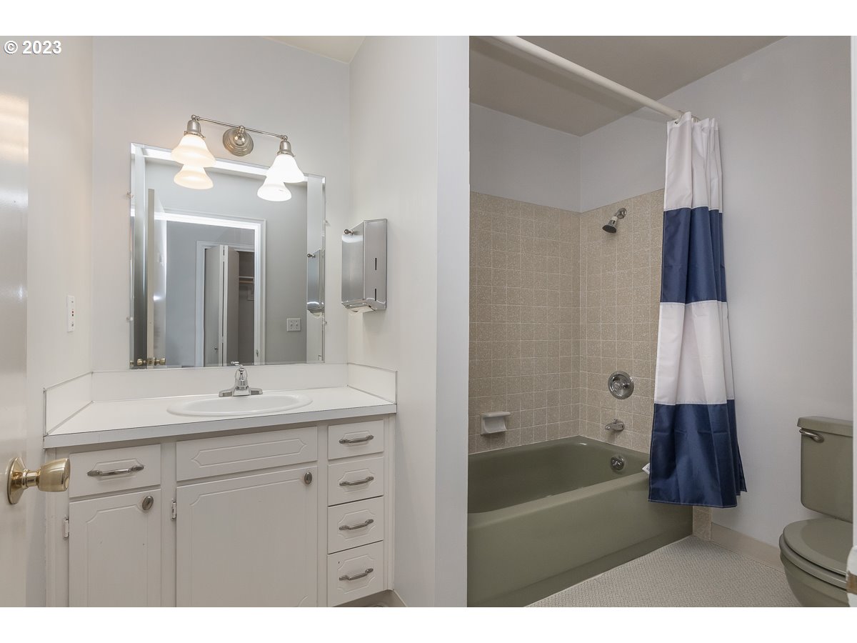 1326 Southwest 12th Avenue Portland, OR 97201 - Photo 10 of 33 a bathroom with a sink double vanity granite tub shower and a mirror