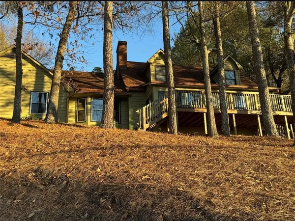 front view of a house with a large tree