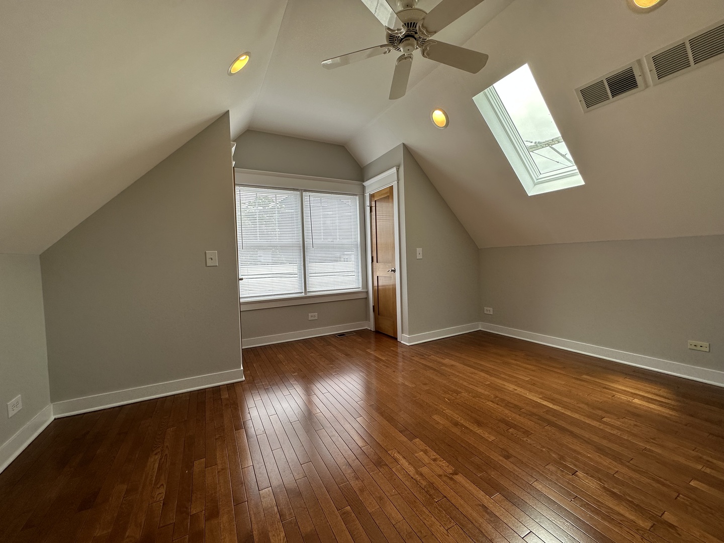 Undisclosed Address Chicago, IL 60613 - Photo 11 of 12 an empty room with wooden floor fan and windows