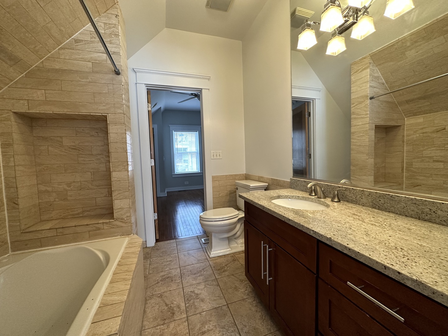 Undisclosed Address Chicago, IL 60613 - Photo 12 of 12 a bathroom with a granite countertop sink toilet and shower