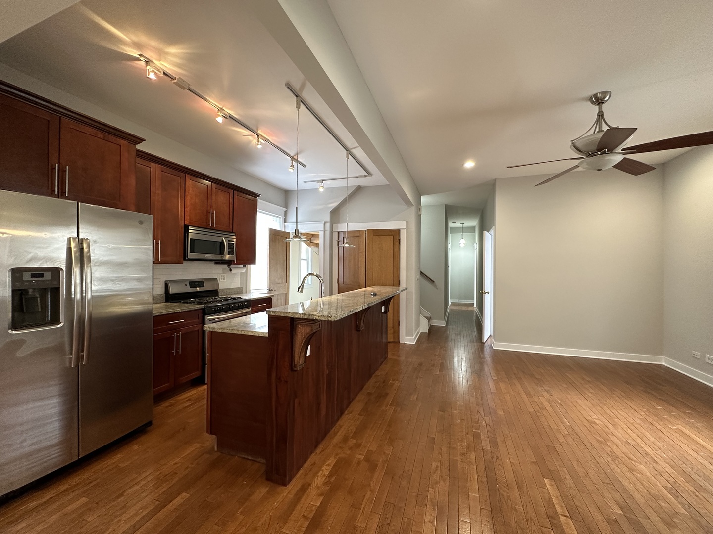 Undisclosed Address Chicago, IL 60613 - Photo 2 of 12 a kitchen with stainless steel appliances granite countertop a refrigerator a sink dishwasher a stove with wooden floors