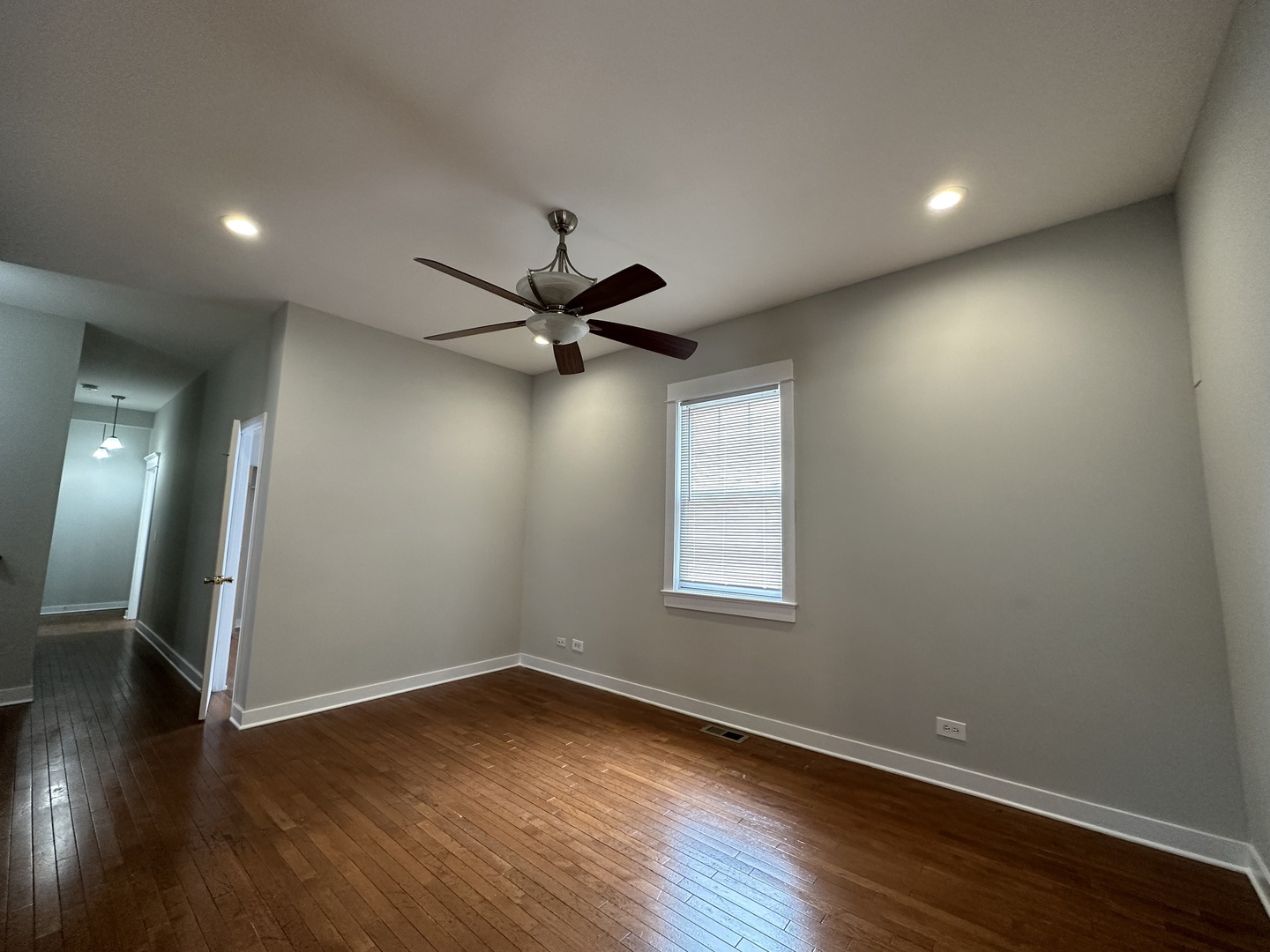 Undisclosed Address Chicago, IL 60613 - Photo 4 of 12 an empty room with wooden floor and windows