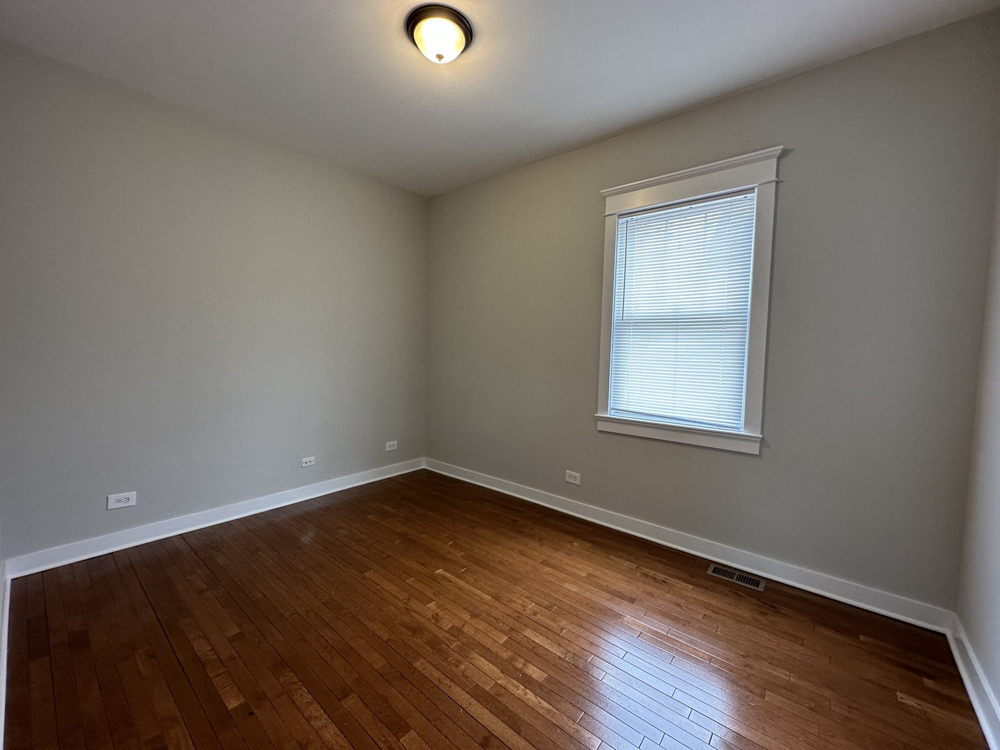Undisclosed Address Chicago, IL 60613 - Photo 7 of 12 an empty room with wooden floor and windows