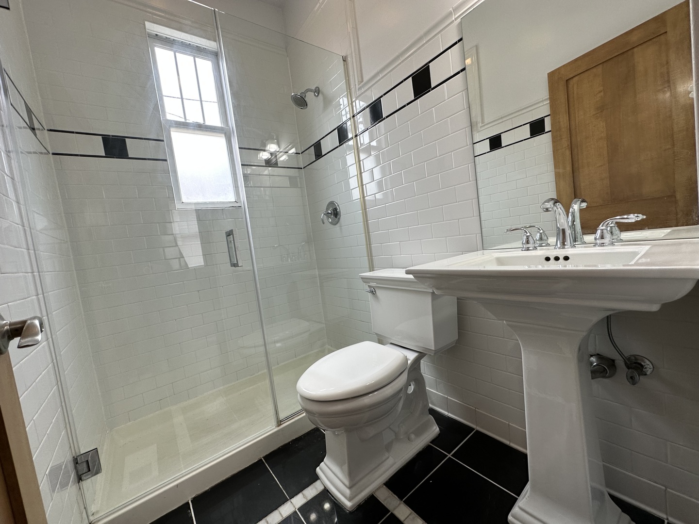 Undisclosed Address Chicago, IL 60613 - Photo 8 of 12 a bathroom with a sink toilet and shower