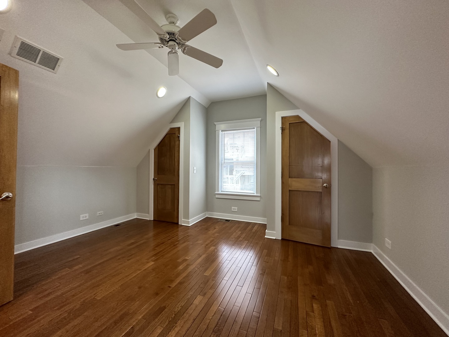 Undisclosed Address Chicago, IL 60613 - Photo 9 of 12 a view of an empty room with window and wooden floor