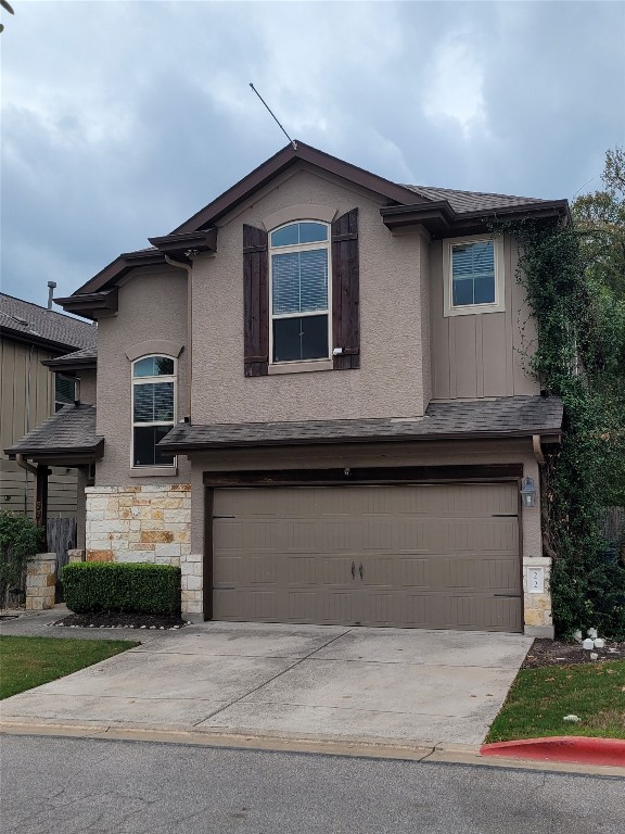 a front view of a house with garage