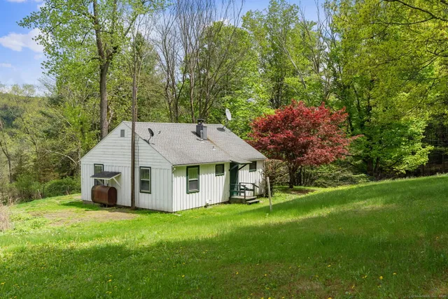 a aerial view of a house with a yard and sitting area