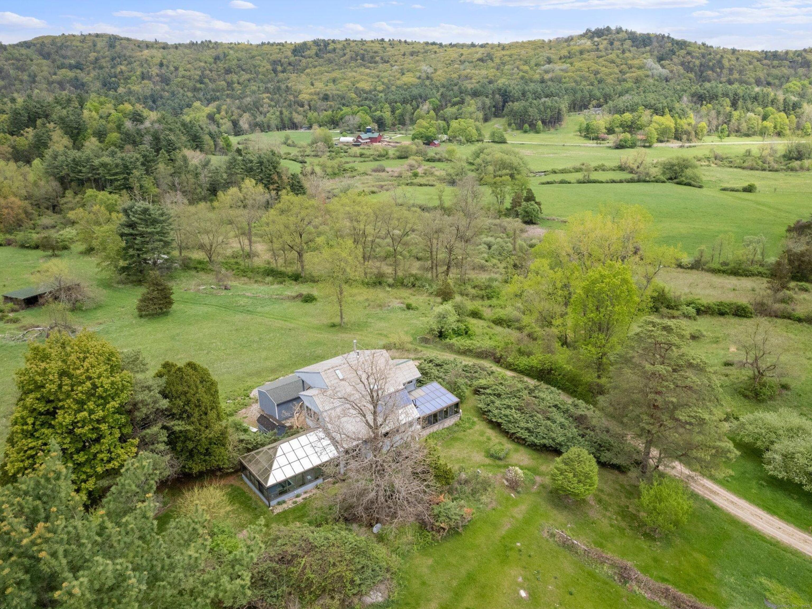 282 Farnum Road Salisbury, CT 06039 - Photo 4 of 22 a view of a lush green forest with a house