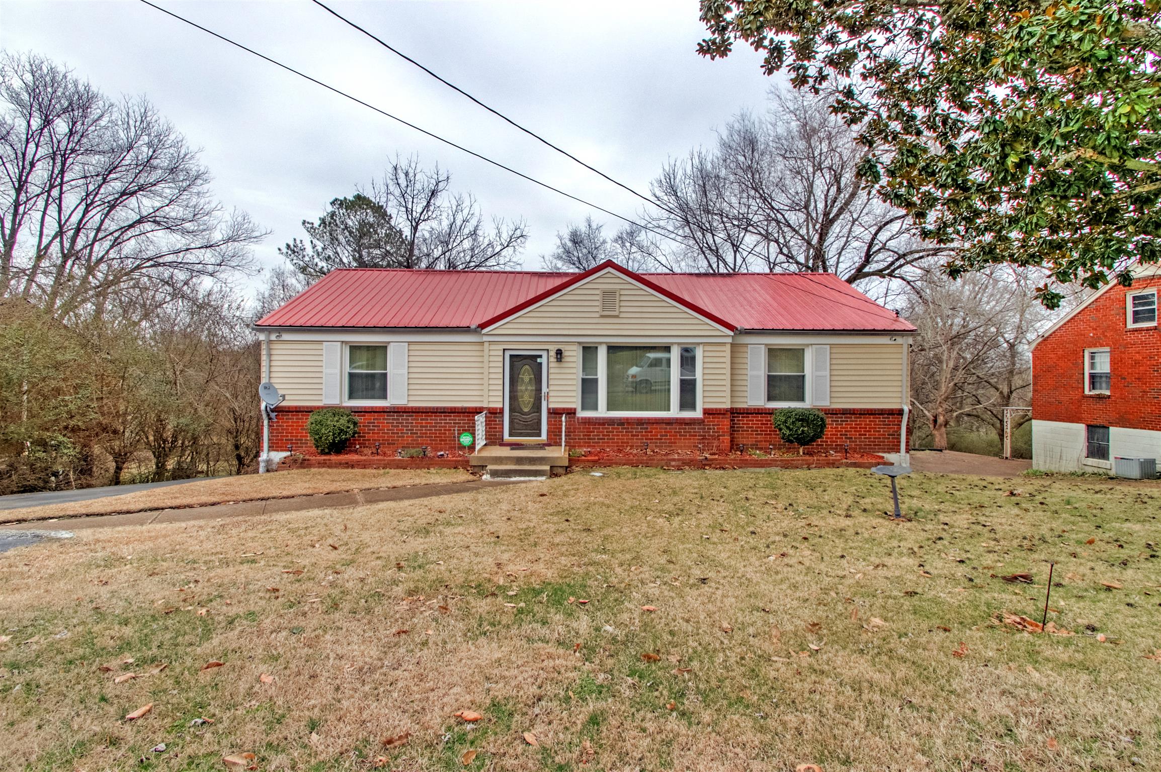 917 Mitchell Road Nashville, TN 37206 - Photo 1 of 19 a white house with a large tree in front of it