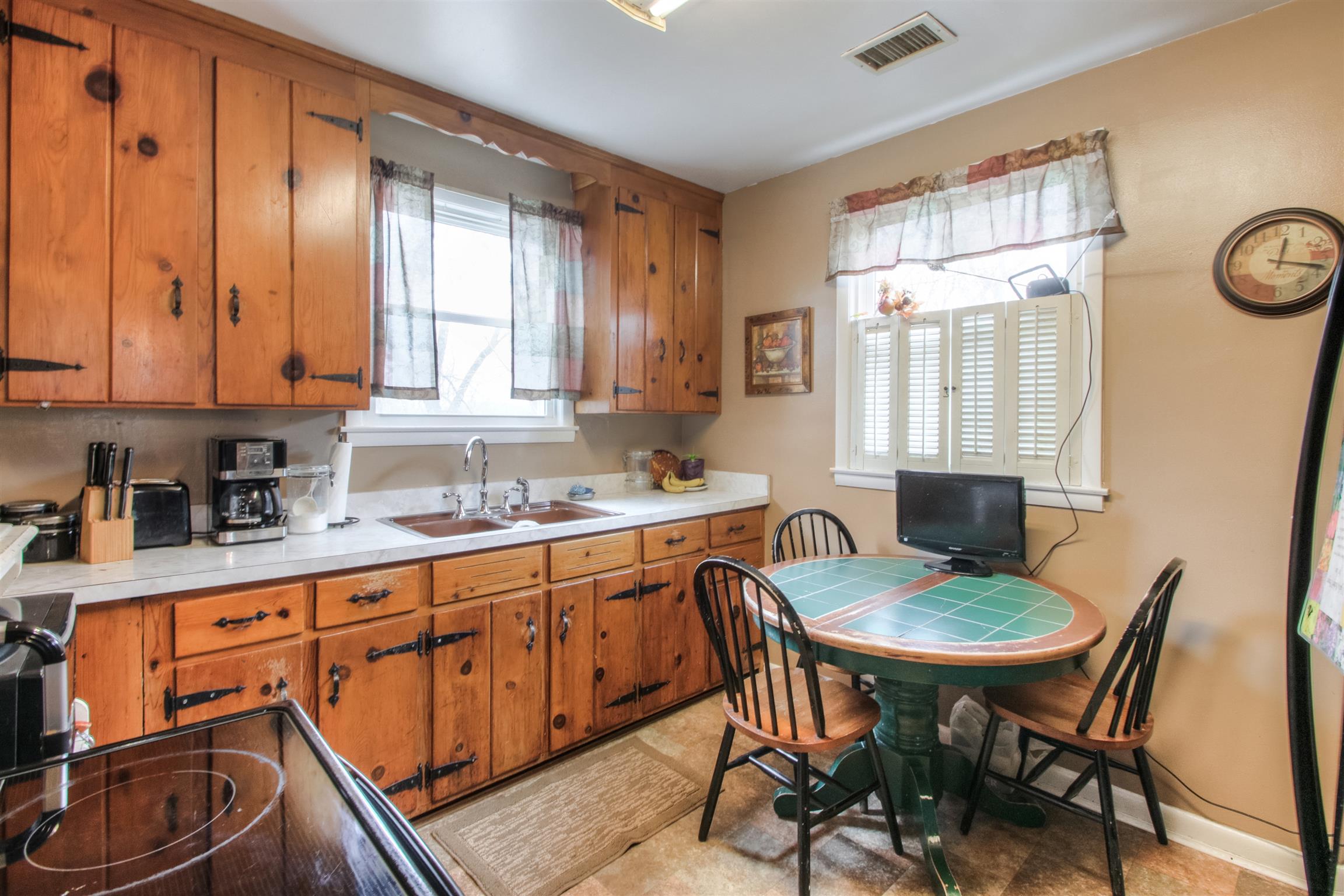 917 Mitchell Road Nashville, TN 37206 - Photo 14 of 19 a kitchen with stainless steel appliances granite countertop a table chairs sink and cabinets
