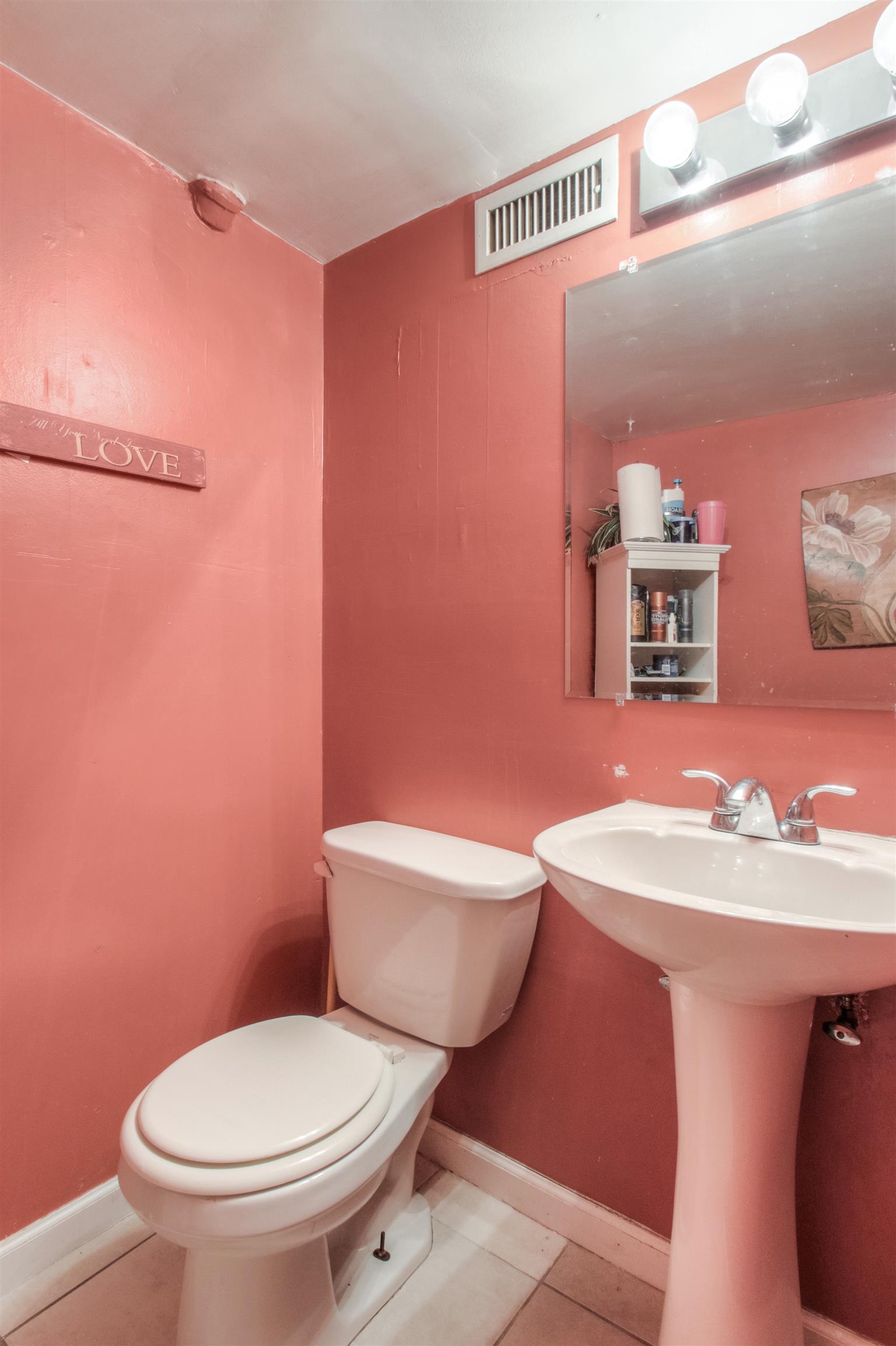 917 Mitchell Road Nashville, TN 37206 - Photo 19 of 19 a white toilet sitting next to a bathroom sink