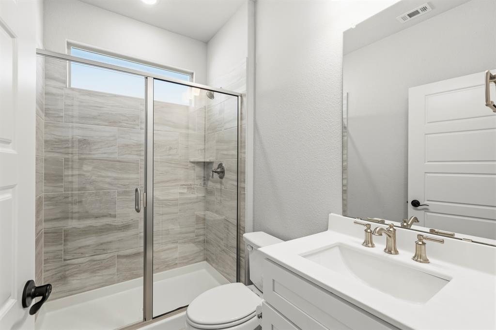 3311 Willena Road Melissa, TX 75454 - Photo 33 of 40 Glass-enclosed shower with a tiled surround and built-in shelf