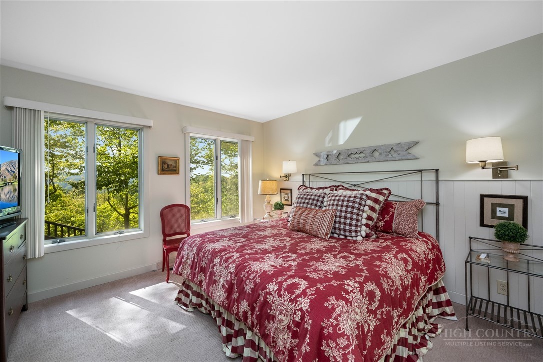 246 Mulberry Lane Boone, NC 28607 - Photo 37 of 49 a bedroom with a large bed and a large window