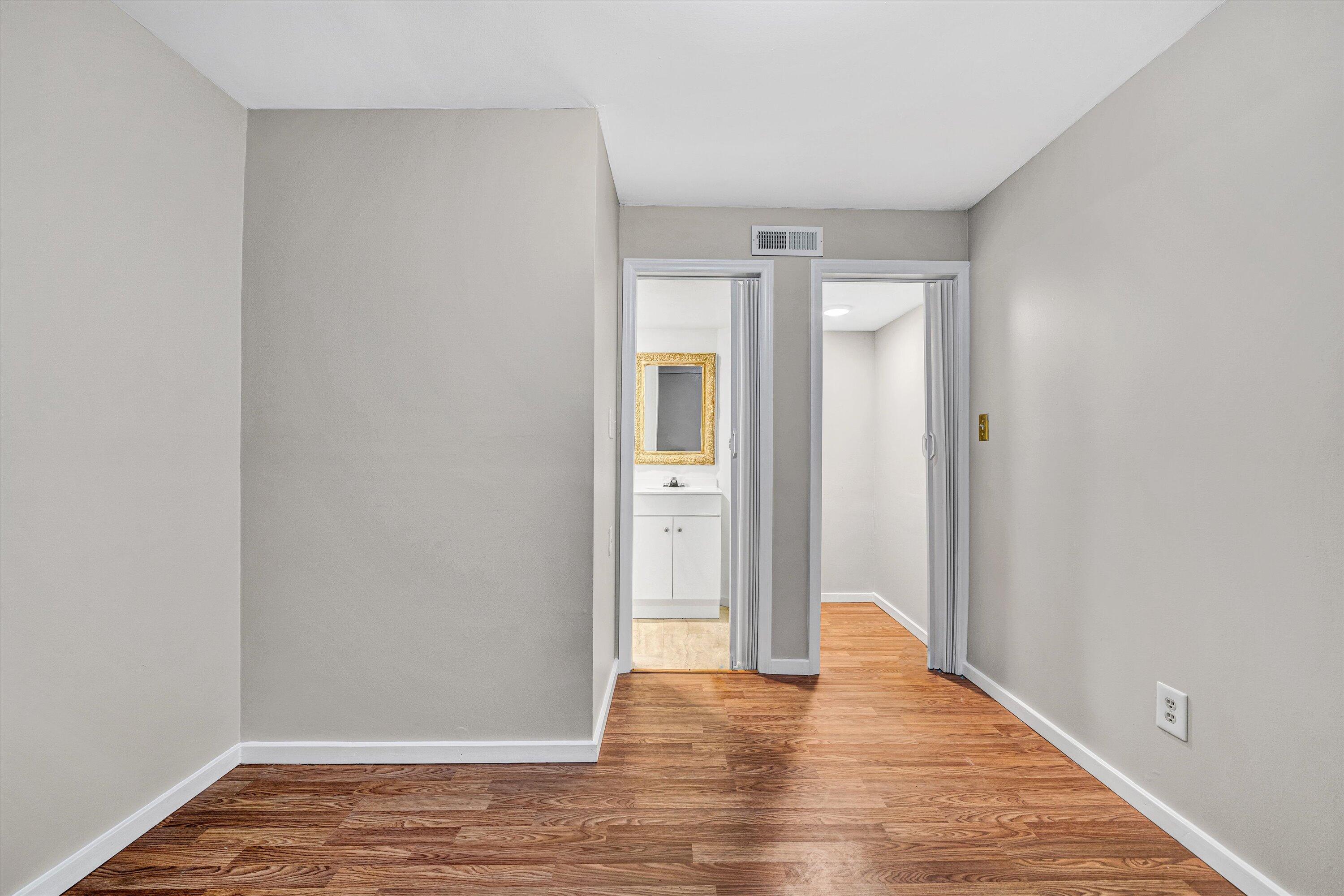 7311 Maple Court Southwest Roanoke, VA 24018 - Photo 31 of 41 a view of an empty room with wooden floor and a bathroom