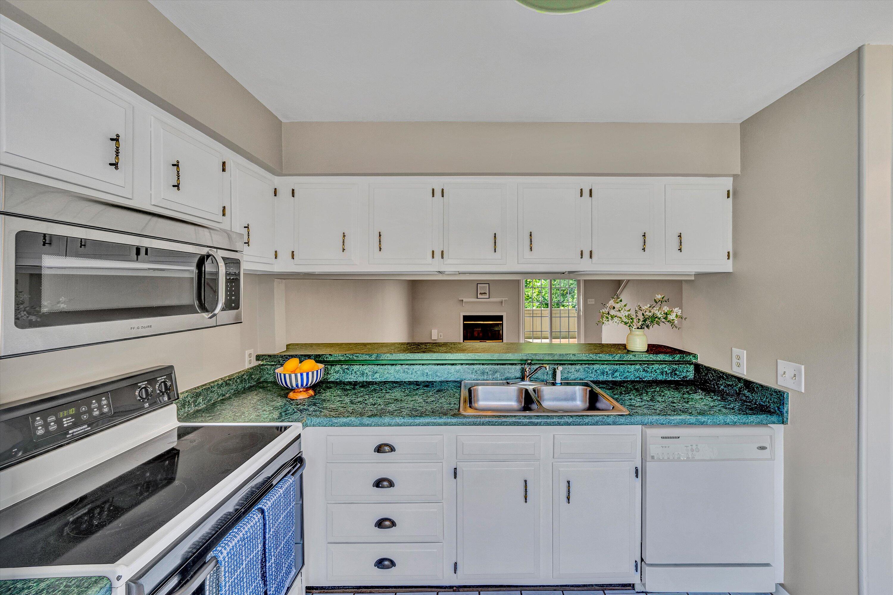 7311 Maple Court Southwest Roanoke, VA 24018 - Photo 9 of 41 a kitchen with granite countertop white cabinets and stainless steel appliances