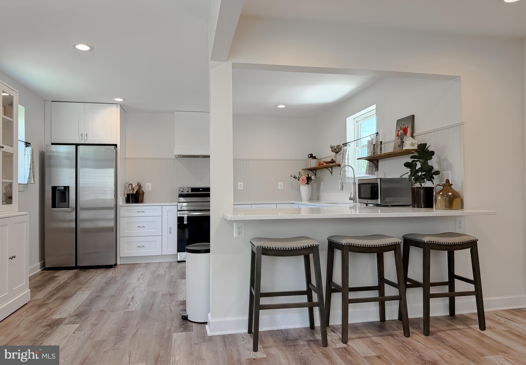 4985 Solomons Island Road Huntingtown, MD 20639 - Photo 6 of 50 a kitchen with refrigerator a microwave and cabinets