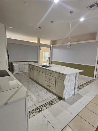 a kitchen with a sink and cabinets