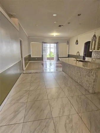 a view of a kitchen with a sink and chandelier