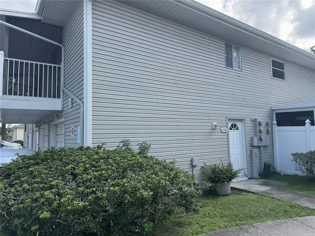 a view of a house with a yard and plants