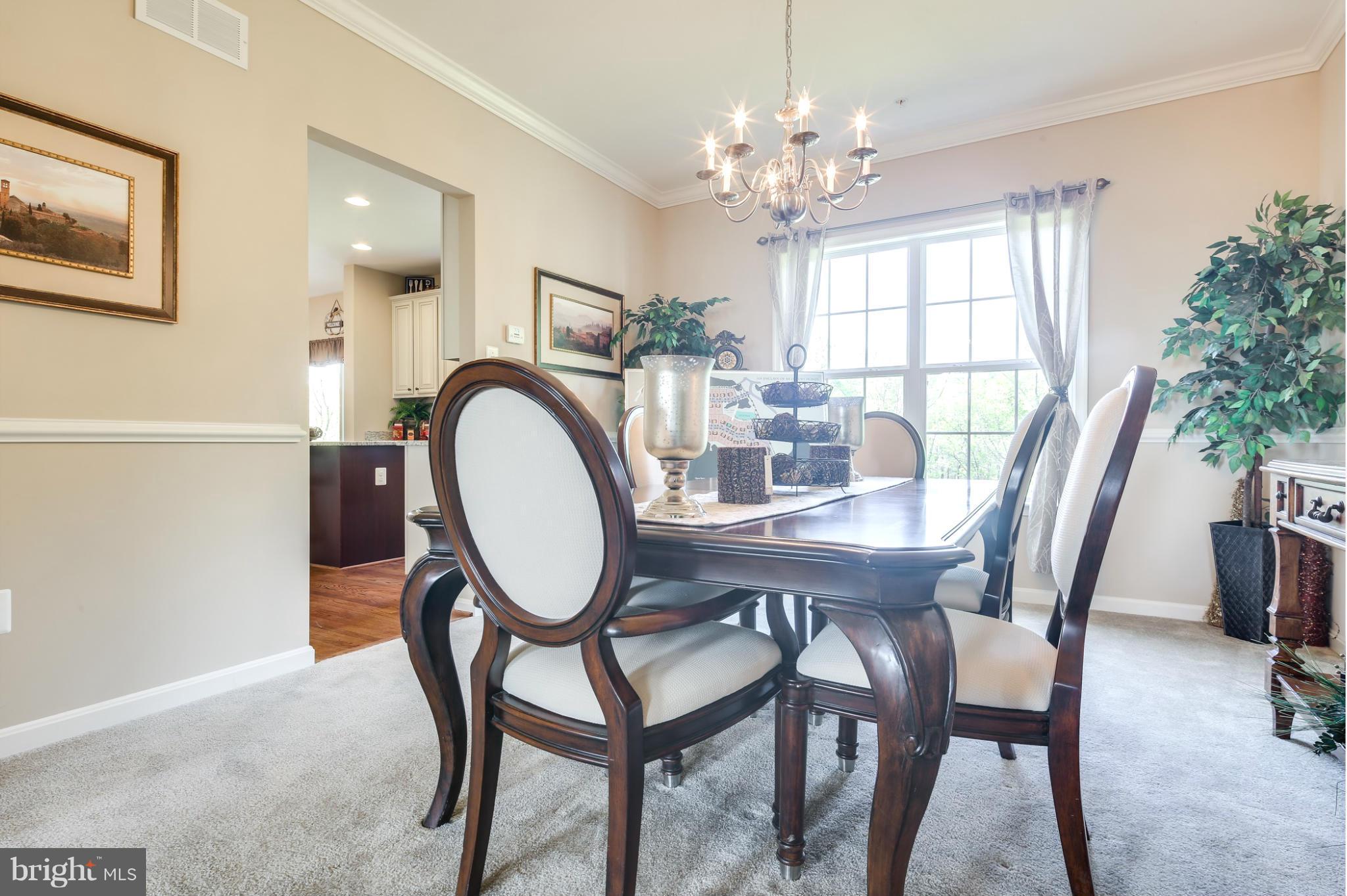 6020 Cypress Springs Road Elkridge, MD 21075 - Photo 13 of 29 a dining room with furniture a chandelier and wooden floor