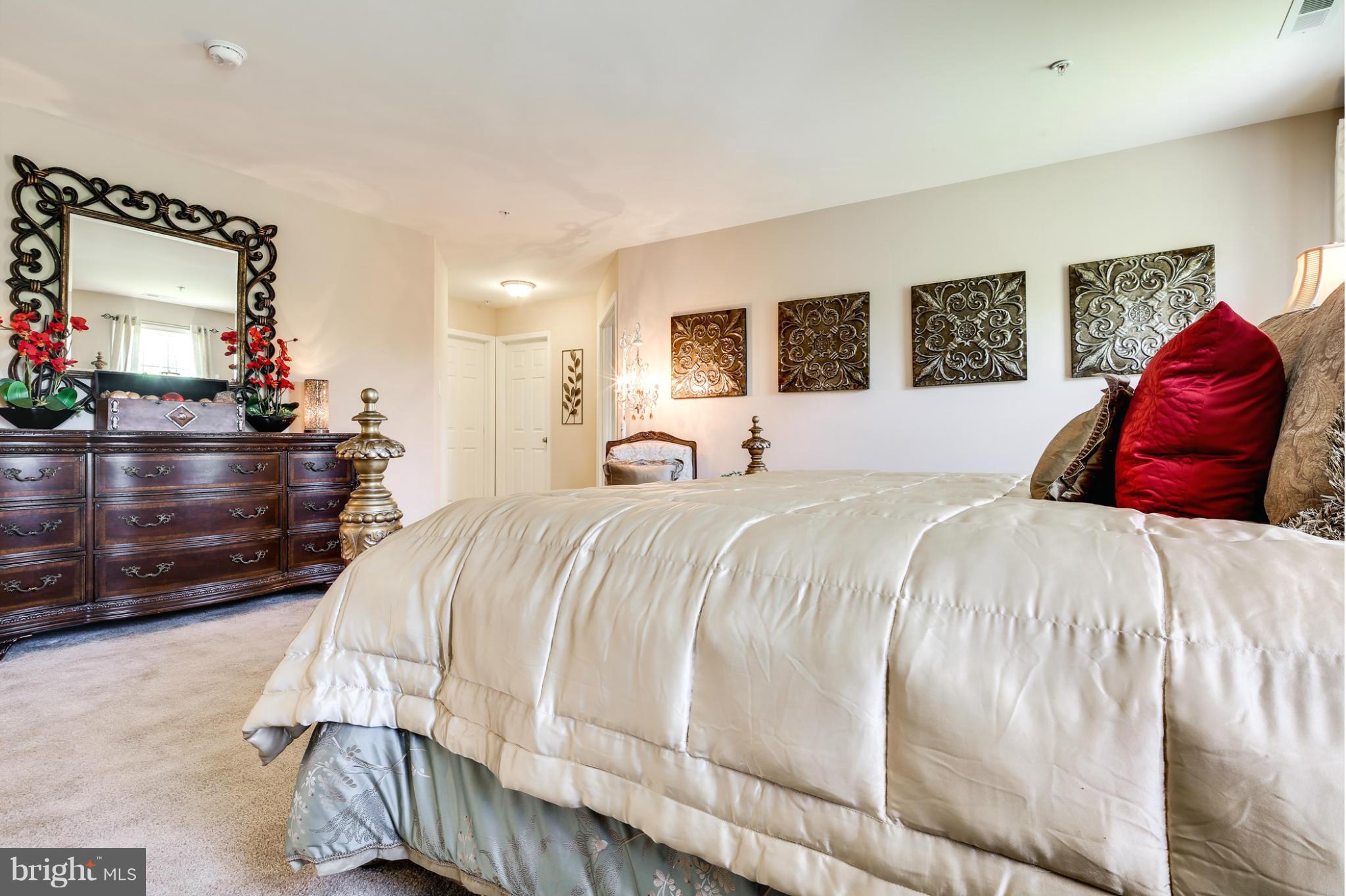 6020 Cypress Springs Road Elkridge, MD 21075 - Photo 21 of 29 a bedroom with a large bed and a large mirror
