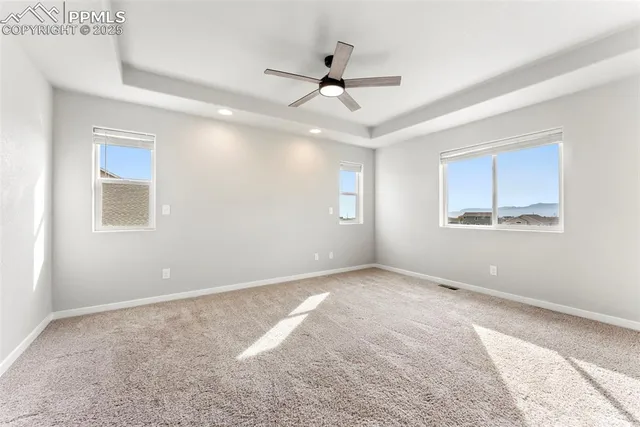 a view of a livingroom with a ceiling fan and window