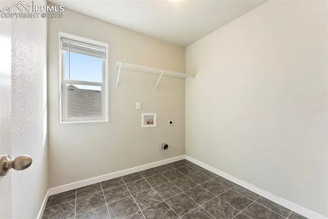 an empty room with a ceiling fan and carpet