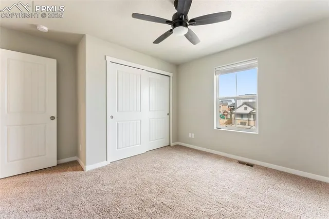 an empty room with windows and cabinet