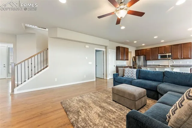 a living room with furniture and kitchen view