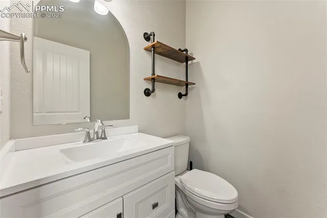 a kitchen with stainless steel appliances granite countertop a refrigerator a stove a sink a microwave and a refrigerator