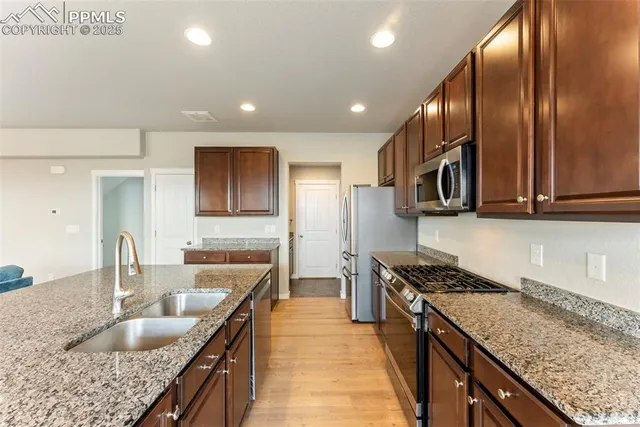 a view of a kitchen with cabinets and stainless steel appliances