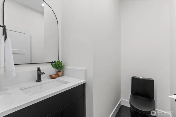 a bathroom with a sink a toilet and mirror