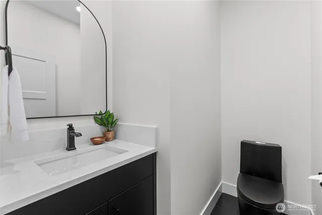 a bathroom with a sink a toilet and mirror
