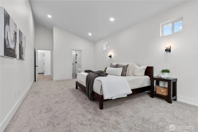 a spacious bedroom with a bed and a couch