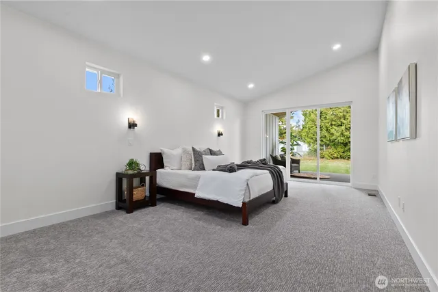 a spacious bedroom with a bed and a window