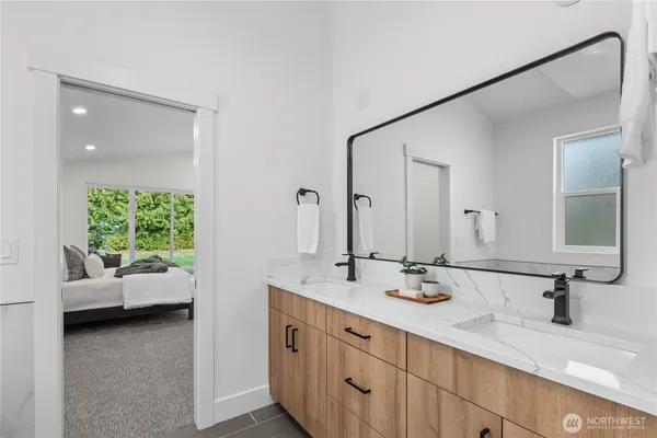 a bathroom with a double vanity sink and a mirror