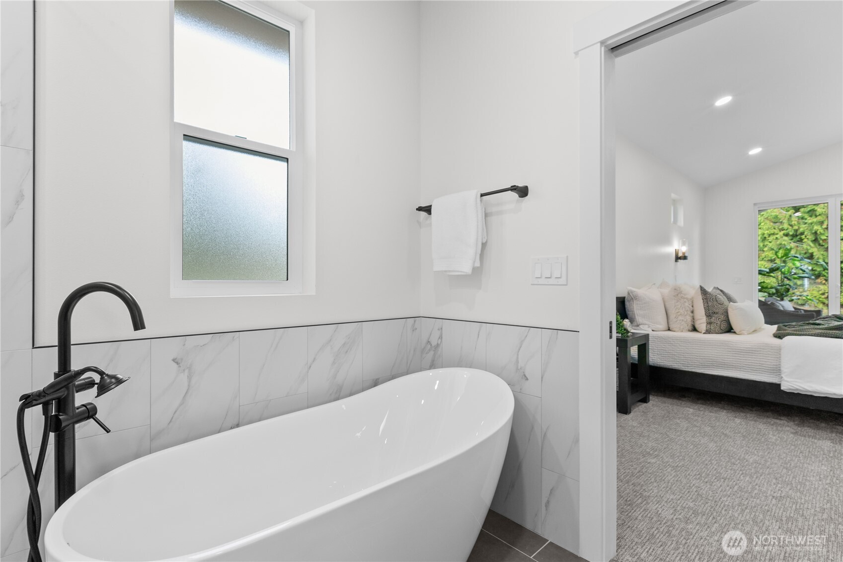 6917 Red Ridge Drive Lynden, WA 98264 - Photo 15 of 40 a bathroom with a bathtub and a window