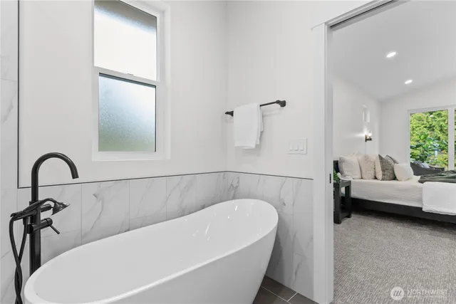 a bathroom with a bathtub and a window
