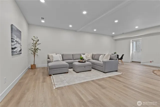 a living room with furniture and wooden floor