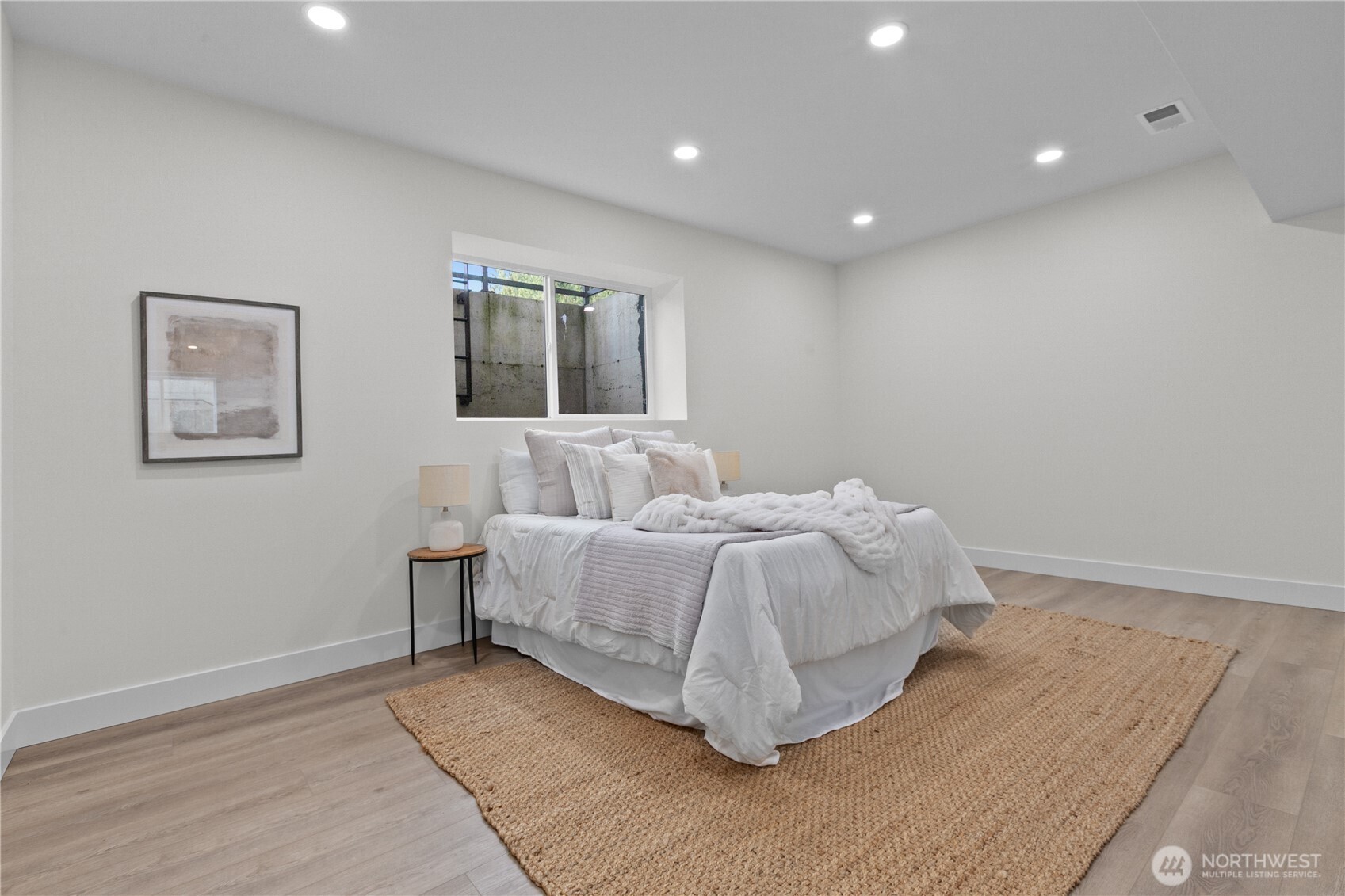 6917 Red Ridge Drive Lynden, WA 98264 - Photo 19 of 40 a spacious bedroom with a bed and painting on the wall