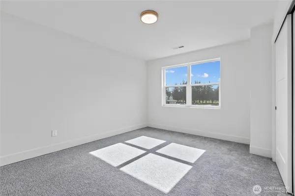 an empty room with windows and closet