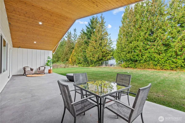 a view of yard with seating area and trees